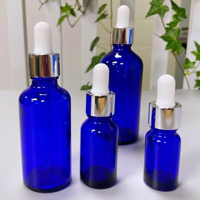 China Aluminum Shiny Silver Rubber Nipple Amber Blue Glass Bottle for sale