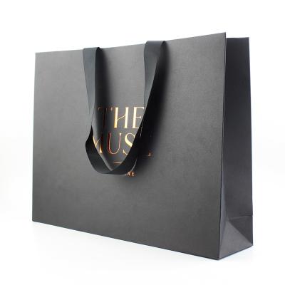 China Disposable Popular Design Printed Craft Matt Black Paper Gift Packaging Custom Bag For Clothes for sale