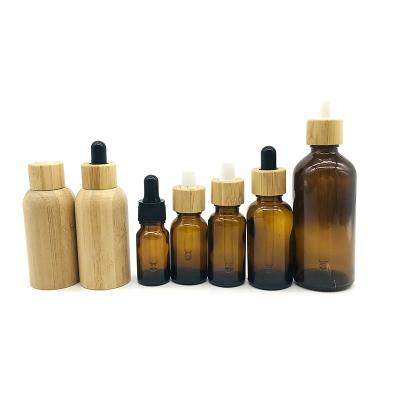 China Wholesale 10ml 15ml 30ml 50ml Bamboo Oil Bottles Eco-friendly Recyclable Amber Glass Bottle New Design for sale