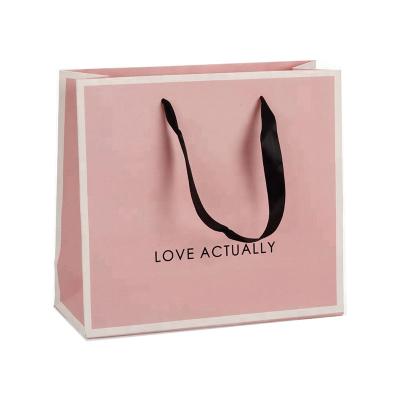 China Recyclable Wholesale Custom Branded Satin Ribbon Handle Luxury Pink Kraft Paper Shopping Bag With Logo Printing for sale