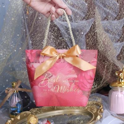 China Recyclable Gift Bag Wedding Candy Box Wedding Celebration Hand Gift Bag Stamped Bowknot Tote Kraft Shopping Paper Bag for sale