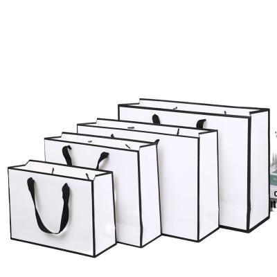 China Recyclable High Quality Luxury Paper Shopping Bag 230Gsm With Handle Art Paper Packaging Bag For Clothes Shoes Gift for sale