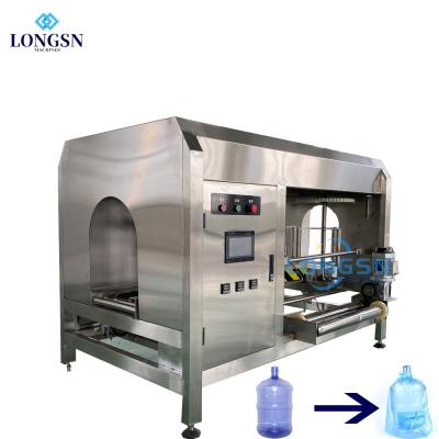 China High Efficiency Automatic Pure Water 3-5 Gallon Bottle Barrel Bagging Packing Machine With Plastic Bags for sale