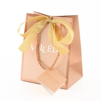 China Recycled Materials Luxury Custom Shopping Paper Bag With Logo Wholesale Gift Packing With Ribbon Handle for sale