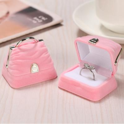 China Customized Funny Pink Jewelry Box Ring Earrings Storage Hand Bag Velvet Jewelry Box Shape Baby Jewelry Box for sale