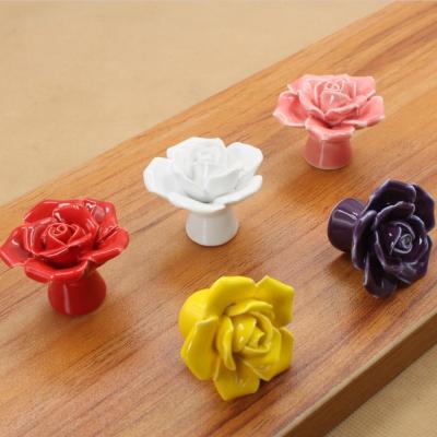 China Modern Rose Ceramic Handle Cabinet Wardrobe Pulls Hand Pinch Cartoon European Modern Simple Color Flower Handle for sale