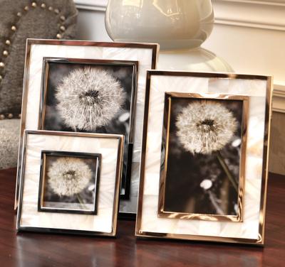 China Natural Shell Material Framed Family Portrait Nightstand Desktop Decoration Alloy Frame Fashionable Gold Photo Picture Frames 4/6/7 inch for sale