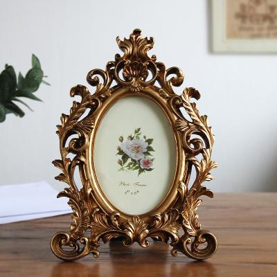 China Home Decoration Ornaments Ornaments Gift of Retro Photo Frame Resin Picture Frame Wedding Party Gold Fashionable Oval Desk Frame 6/7/8 inch for sale