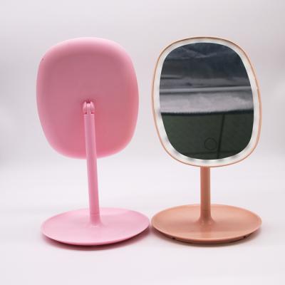 China New Lighted Touch Sensor Makeup Mirror LED Desktop Mirror Smart Oval Makeup Table With Light for sale