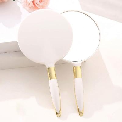 China Portable. Low MOQ Customized Wholesale Automatic Design Woman Round Pocket Makeup Magic Plastic Hand Held Single Sided Mirror for sale