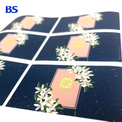 China Customized Waterproof Printed Logo Foil Transparent Bottle Sheet Label Self Adhesive Waterproof Stickers Black Gold Hot Stamping for sale