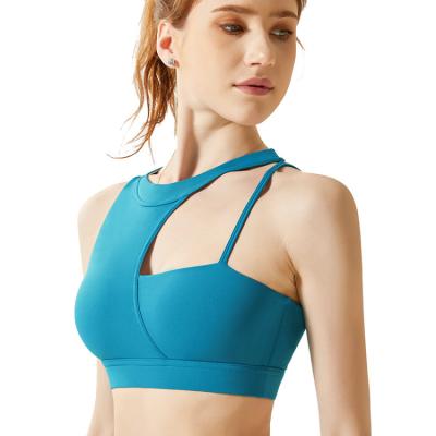 China Antibacterial Women's Irregular Shoulder Strap Padded Sports Bra Yoga Shockproof Beautiful Back Radio Support Bra for sale