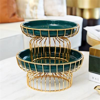 China Viable European Art Ceramic Fruit Bowl Green Living Room Iron Fruit Dish Ceramic Snack Candy Dish With Metal Stand for sale