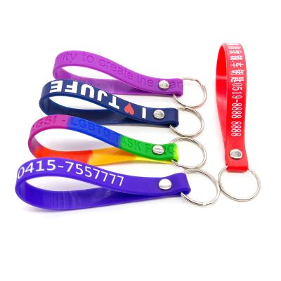 China Low MOQ Silicone Rubber Wristband Wristband Keychain Holder Phone Key Chain With Custom LOGO for sale