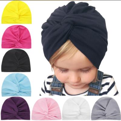 China High Quality Cross Pom Pom Winter Baby Knit Front Polyester Hats for sale