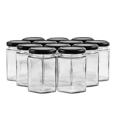 China Food Hexagon Glass Jar 500ml 180ml Hexagon Glass Honey Jar With Metal Lid for sale