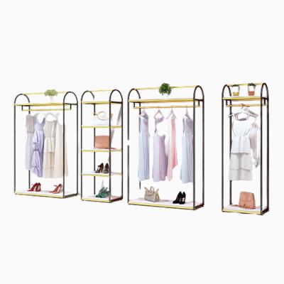 China Clothes Shop Wholesale Floor Standing Boutique Commercial Black and Gold Stainless Steel Garment Store Commercial Clothing Rack for sale