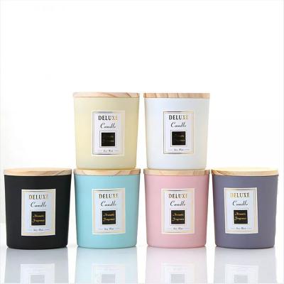 China Elegant creative multicolor frosted transparent black white home decoration candle jars with wooden lids for sale