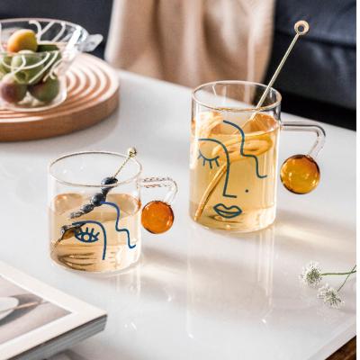 China Modern cute and creative human face graphics water wine fruit juice milk glass transparent cup for sale