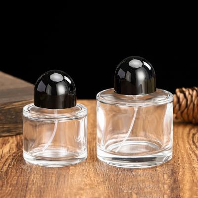 China 30ml 50ml 100ml Round Glass Perfume Bottles with Stock Fragrance Pump Spray and Empty Oil Packaging for sale