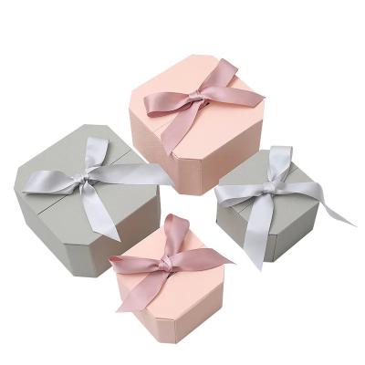 China Custom Creative Pink Hexagonal Gift Box Clamshell Jewelry Packaging Paper Box with Ribbon for sale