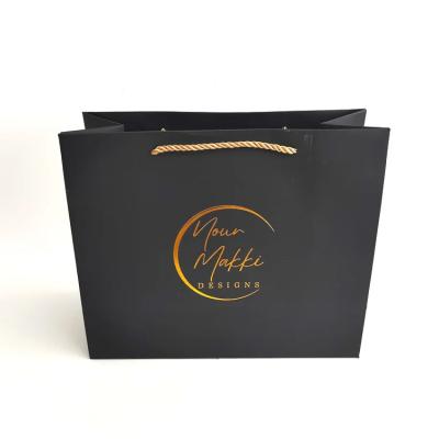 China Wholesale custom logo gold foil Logo luxury black gift bags shopping cardboard paper bags for sale