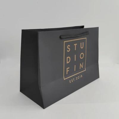 China Luxury black cardboard paper bag shoes clothing gift handbag paper bag custom print logo for sale