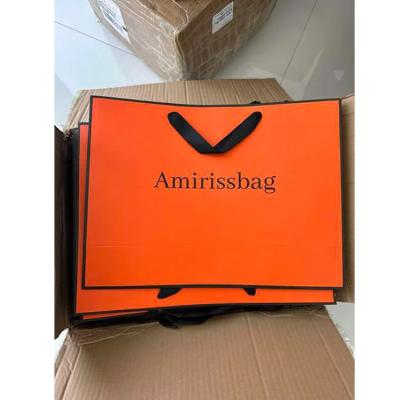 Chine Emballage cadeau personnalisé sac en papier d'emballage orange personnalisé emballage artisanal sacs en papier d'emballage orange avec logo personnalisé à vendre