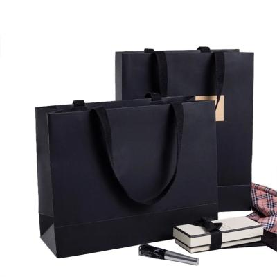 China Thicker sticker rope kraft paper bags tote bags printing logo paper gift clothing store packaging bags for sale