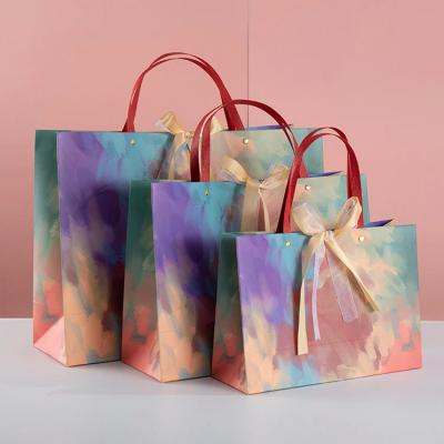 China Impresión de logotipo personalizado Bolsa de compras de papel ropa zapatos marca famosa naranja gafas de sol Bolsa de papel en venta