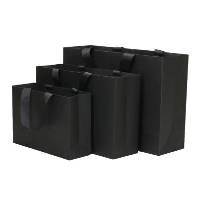 China Recyclable Packaging Retail Clothing Black Cardboard Paper Bag with Black Ribbon Handle for sale