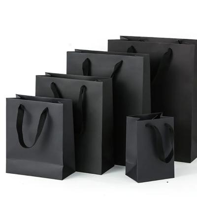 China Wholesale black gift bags paper bags packaging clothing black cardboard printed LOGO tote bags for sale