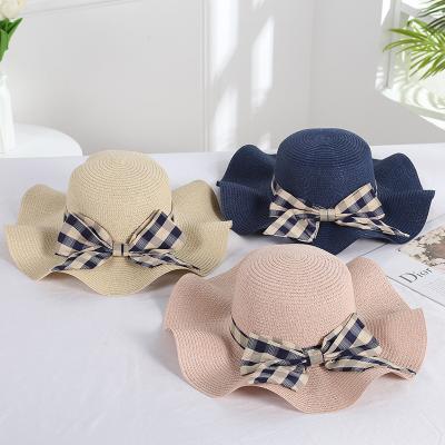 China Foldable And Easy To Wear Simple Korean Style Plaid Bow Woven Sun Hat Fashion Ladies Beach Hats Straw for sale