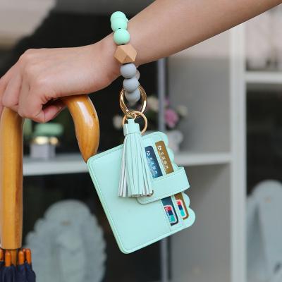 China Fashion 2021 Suede Cuentas Llavero De Madera Beads Bracelet Key Chain Bead Fashion Elastic Tassel Wooden Circle Circle Summer Silicone Key Chain for sale