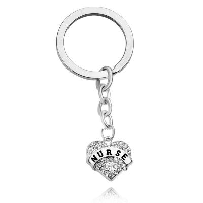 China Best Selling Crystal Heart Key Chain Wholesale Promotion Alloy Silver Plated Heart Nurse Crystal Key Chain for sale