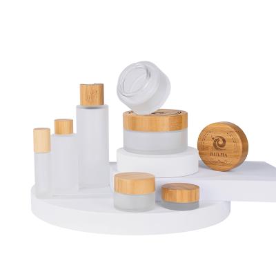 China clear frosted cosmetics cream glass bottles and jars Wooden Bamboo lid for sale