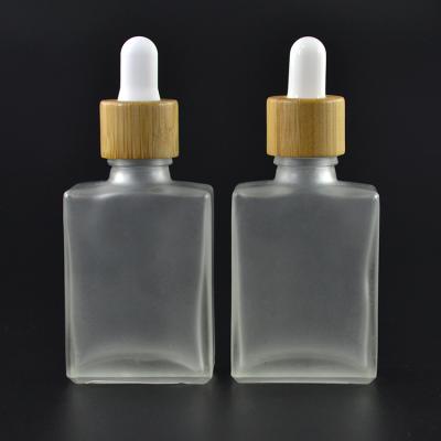 China new product rectangular 30ml clear frosted glass dropper bottle with bamboo cap for sale