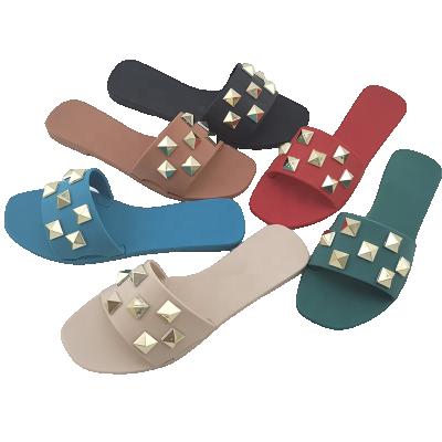 China CUSHIONING Lady Flat Plastic Sandals Freeze Shoes Rivet Slippers for sale