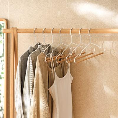 China Sustainable Profession Design Black Metal Coat Hanger With Wooden Pants Bar For Hotel Bedroom for sale