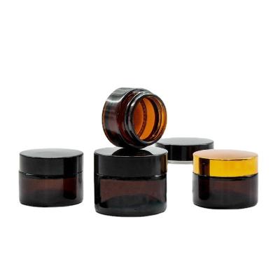 China 5g 10g 15g 30g 50g 100g 1oz Amber Glass Cream Jar With Cosmetic Empty Clear Gold Black Silver Aluminum Lid for sale