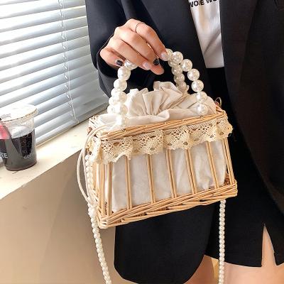 China Fashion Pearl Bag 2021 New Handbag Portable Straw Woven Bag Messenger Handbag Seaside Beach Woven Bag for sale