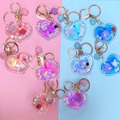 China New Design Cute Sea Crylic Colorful Shining Flow Of Heart Liquid Marine Bottle Doll Pendant Keychains for sale