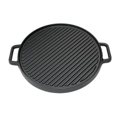 China Easily Cleaned Cast Iron Reversible Pre-Seasoned Griddle Multifunctional Round Double Sided Non Stick Grill Pan With Handles And Stripes for sale