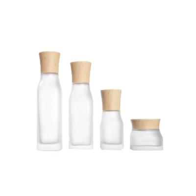 China Empty Translucent Frosted Glass Cosmetic Skin Care Cream Essential Oil Aromatherapy Perfume Liquid Containers With Wood Grain Cap for sale