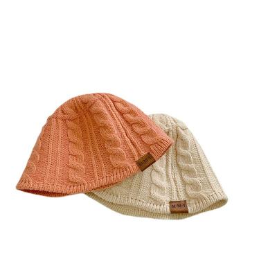 China Dobby Kids Knitted Hat Baby Fisherman Autumn/Winter Cowhide Label Hemp Flat Top Bucket Hat for sale