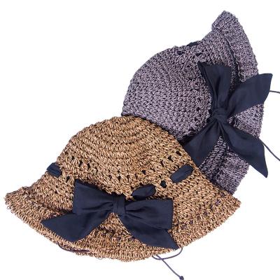 China Dobby Hollow Out Comfort And Bowknot Beach Floppy Hat Handmade Women Straw Hat for sale