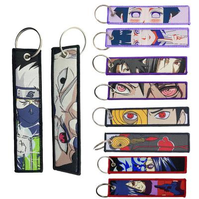 China Promotion Gift Keychain Souvenir Promotional Gift Cheap Cartoon Anime Custom Souvenir Keychains Double Sided Woven Embroidery Fabric Jet Tag Key Ring for sale