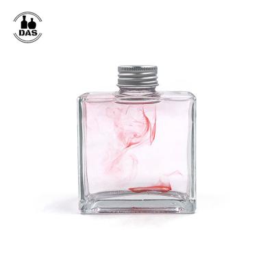 China Eco-friendly Multiple Uses Glass Diffuser Bottle Drink Bottle 200ml Square Liquor Bottle With Screw Lid for sale