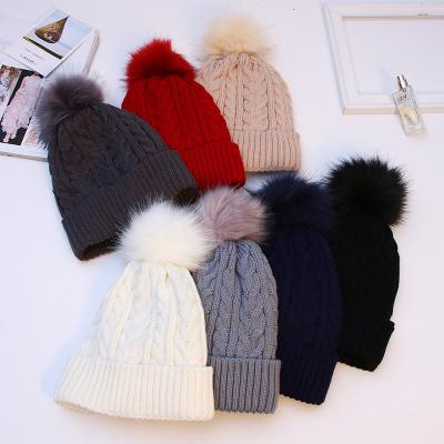 China COMMON Winter Knitted Pom Pom Beanie Women Hat Wholesale Fashion Custom Women Thick Beanie Cap for sale