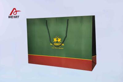 China Special Customized Paper Bags Blue Color Embossed Logo With Blue Handle for sale